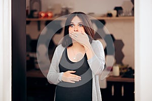 Pregnant Woman Feeling Sick in Her Kitchen photo