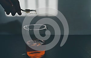 A girl is experimenting something with some chemicals in chemistry lab
