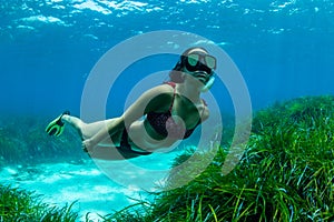 a girl explores the depths of the sea