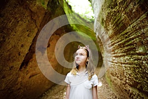 Girl exploring Etruscan Le Vie Cave Via Cava, the path connecting ancient necropolis and settlements in the area between Sovana