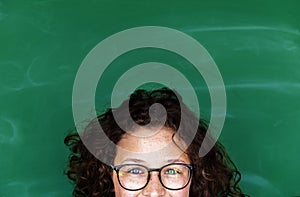 A girl with eyeglasses and blackboard photo