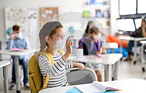 Girl with face mask back at school after covid-19 quarantine and lockdown.