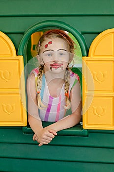 Girl with facepainting in colorful house