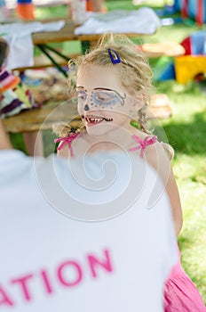 Girl with facepainting smiling