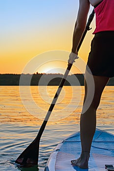 Girl family man woman are doing yoga on a sup