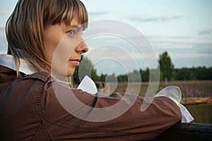 Girl at the farm fence