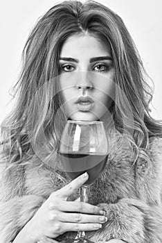 Girl fashion makeup wear fur coat hold wine glass. Woman drink wine. Lady fashion model curly hairstyle likes expensive