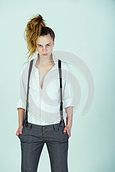 Girl in fashionable pants, suspenders and shirt