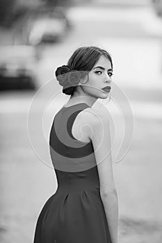 Girl in fashionable, red dress walking on road