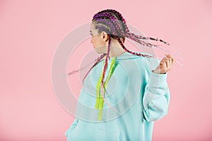 Girl with fashionable set of multicolored braids Kanekalon