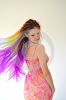 A girl with a fashionable set of multicolored braids Kanekalon. Colored artificial strands of hair.