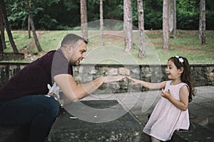 Girl and father playing rock-paper-scissors game