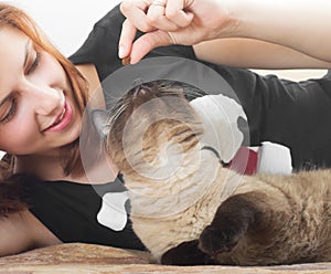 Girl feeding cat