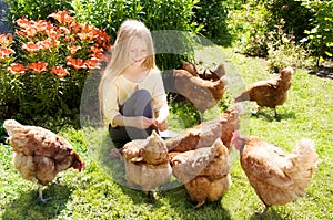 Girl feeding chickens