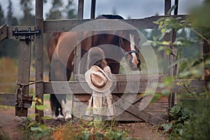 Girl feeding her horse