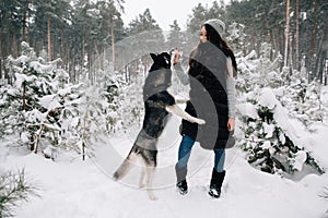 Girl feeding her Husky dog snacks