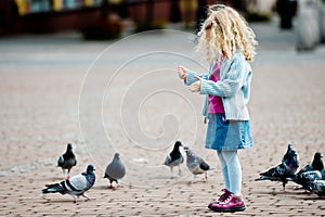 Girl feeding pigeons