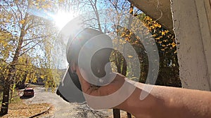 Girl feeds a pigeon that sits on her hand on a sunny autumn day