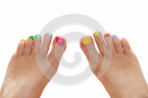 Girl feet with rainbow colorful nails isolated on white