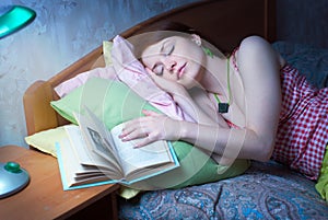 The girl fell asleep with a book