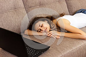 Girl fell asleep with a laptop on the sofa .Tired and fell asleep