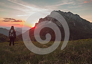 Girl female is looking on sunset in mountains and enjoy life