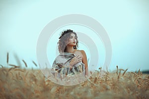 Girl in field covered with a cloth.