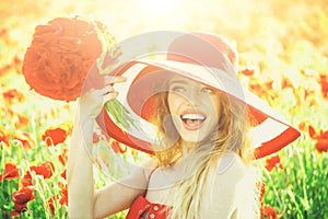 Girl in field of poppy seed in retro hat