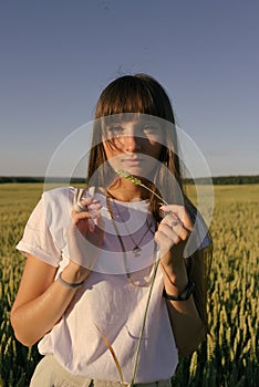 Girl field summer agriculture on green background. Agricultural landscape. Sunny day. Summer season.