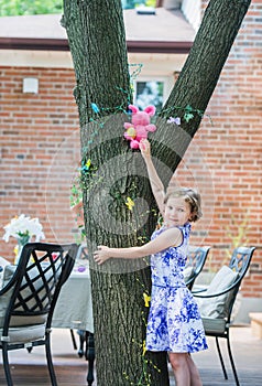 Girl Finds an Easter Egg Up in a Tree photo