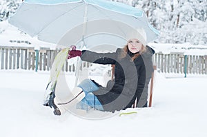 Girl with fins sitting in snow