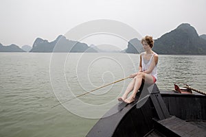 Girl fishing on the boat