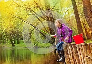 Girl fishing near beautiful pond with fishrod