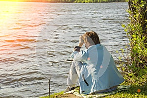 Girl with fishing rod fishing in the pond