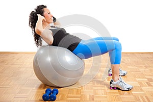 Girl fitness exercising on a ball