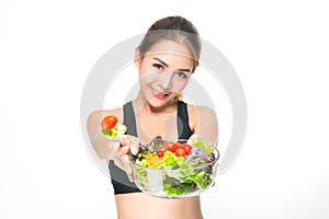 Girl in a fitness suite holds a salad bowl