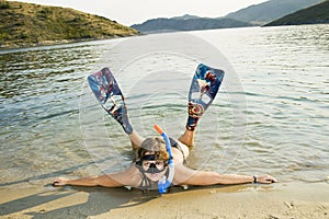 Girl in Flipper lying on the beach photo