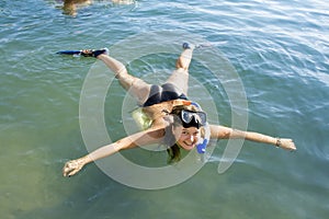 Girl in Flipper lying on the Sea photo