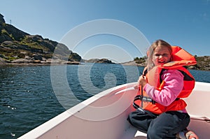 A girl is in a floating boat on open water