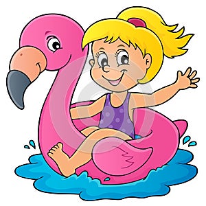 Girl floating on inflatable flamingo 1