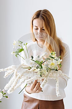 Girl florist assembling a bouquet