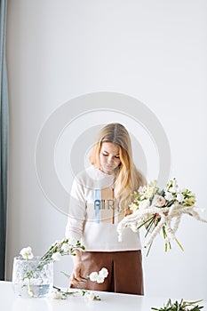 Girl florist assembling a bouquet