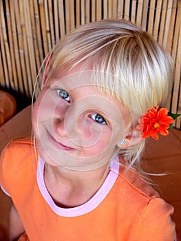 girl with flower behind ear