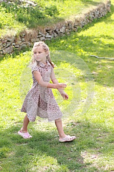 Girl in flowered dress looking back