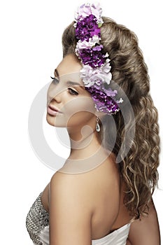 Girl with flowers in a beautiful hairstyle