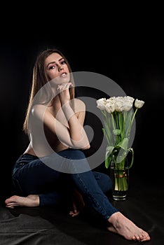 Girl with flowers. Holiday. Tulips in a vase. Sexy girl.