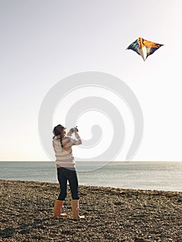 Girl Flying Kite On Beach