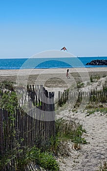 Girl flying a kite. Holidaying at the beach and having fun
