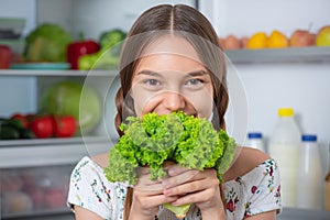 Girl with food near fridge