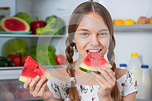 Girl with food near fridge
